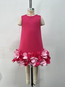 Detail of rose red sleeveless dress featuring layered 3D floral petals on the skirt