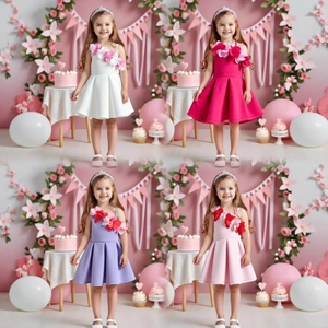 Detail of girls' one-shoulder party dresses in white, rose, purple and pink with floral accents
