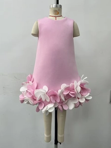 Detailed close-up of 3D layered pink and white floral petals on a girls' dress hem