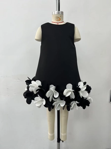 Detail of 3D floral appliqués on the hem of a black sleeveless A-line party dress