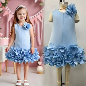 Detail of light blue girls gown with 3D floral petals and matching pearl crown