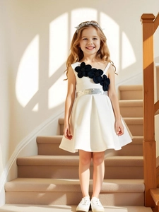 Elegant white girl dress with black floral accents and silver sequin belt for parties