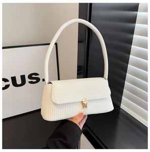 Close-up of beige woven textured PU leather shoulder bag with gold metal square buckle