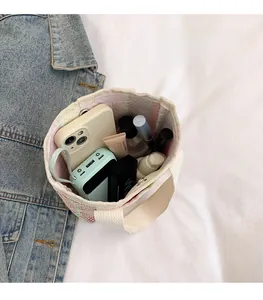 Top view of pink and green woven canvas bucket bag showing large interior storage space