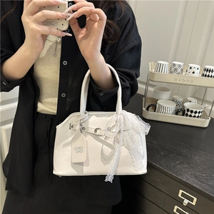 Elegant white shell handbag with delicate lace bow and metallic eyelet strap detail