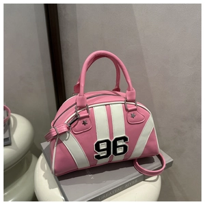 Détail du sac bowling rose et blanc avec écusson numéro 96 et rivets en étoile