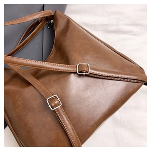 Detailed macro view of dark brown leather texture with silver adjustable metal buckle