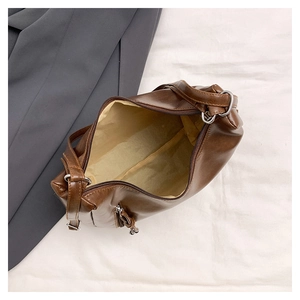 Detailed top view of the spacious inner compartment and smooth brown PU leather of the tote bag