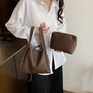 Dark brown pebble leather tote bag set with matching clutch and gold metal hardware