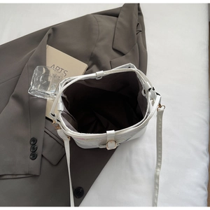 Top view of white bucket bag showing dark brown fabric lining and interior storage
