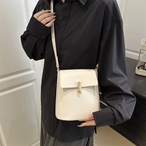 Minimalist cream white crossbody bag with gold pillar lock and matching shoulder strap
