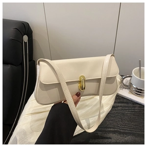 Close-up of cream white shoulder bag with elegant gold metal lock and smooth leather texture