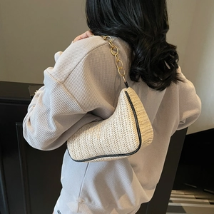 Woven straw underarm bag with gold metal chain strap and black leather trim