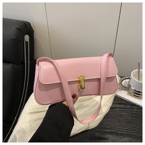 Detail of light pink shoulder bag with gold twist lock on matte leather texture