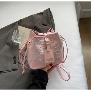 Detail of pink bucket bag with embossed texture and rainbow wavy stitching accents