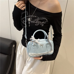 Elegant light blue pillow handbag with white lace bow and adjustable shoulder strap