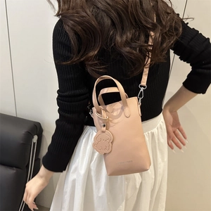 Minimalist beige crossbody phone bag with dog charm and fashion embossed text