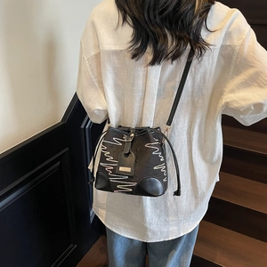 Women's black bucket bag with colorful embroidery on leather and nylon crossbody strap