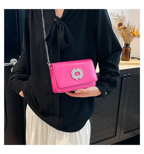 Detail of rose red square chain bag with sparkling crystal buckle and silver metal chain