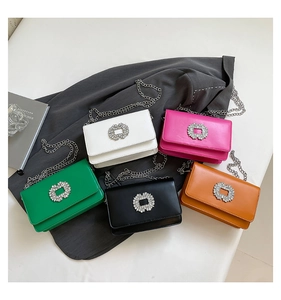 Collection of five colorful crossbody bags with crystal buckles on a minimalist background