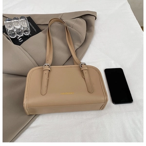 Detail of a chic beige tote bag with silver buckle and 'FASHION & BAG' text