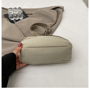 Detail view of khaki nylon tote bag bottom construction and sturdy sewing craftsmanship