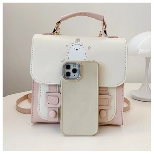 Detail view of pink and white PU leather backpack featuring a cute cat graphic with a phone