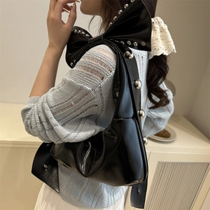 Elegant black bow-shaped shoulder bag featuring silver metallic studs and glossy finish