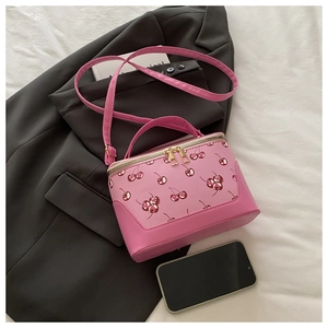 Pink cherry print crossbody bag detail with smooth zipper and faux leather top handle