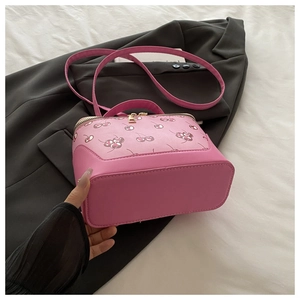 Detail of pink cherry print Boston bag with top handle and gold zipper hardware