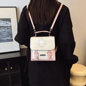 Preppy style pink and beige patchwork backpack with cute cartoon illustration on back