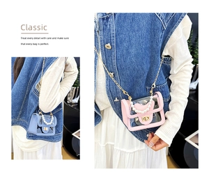 Detail of transparent PVC mini bag with pearl handle and golden chain strap in pink and blue