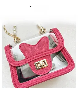 Detailed view of pink transparent crossbody bag with bow flap and pearl chain strap