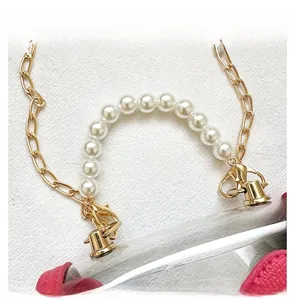 Detail display of transparent PVC bag with pink faux leather trim and pearl top handle