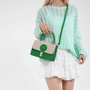 Minimalist green and beige patchwork crossbody bag with metallic clasp on a model