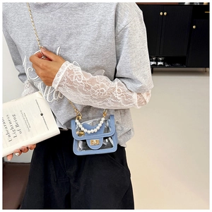 Detail of transparent PVC mini bag with cat-ear flap and elegant pearl handle