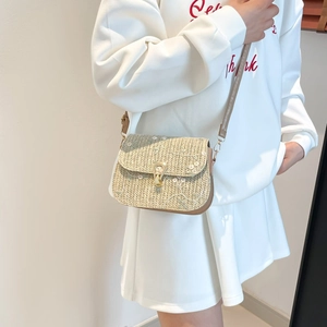 Handcrafted woven straw shoulder bag with floral embroidery and golden metal lock