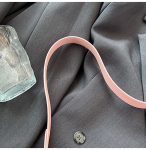 Detailed view of the pink matte faux leather shoulder strap with premium stitching