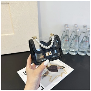 Detail of transparent mini bag with elegant pearl handle and golden chain strap