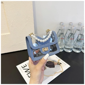 Detailed shot of transparent blue PVC mini bag with pearl handle and gold chain strap