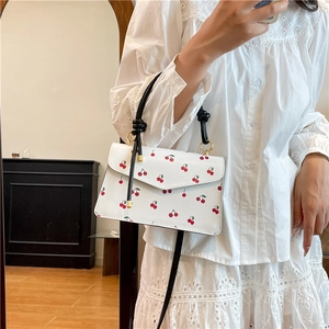 Chic white square crossbody bag with red cherry prints and black handle for summer style