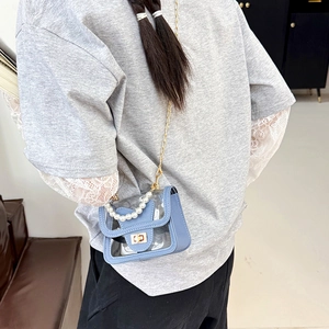 Sky blue transparent crossbody bag with pearl handle and golden chain strap