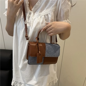 Contrast color handbag with brown leather and blue denim stitching for daily fashion look