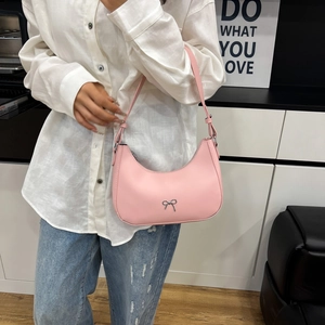 Chic pink hobo underarm bag with silver bow ornament and leather shoulder strap