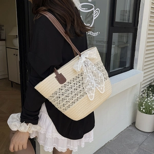 Beige woven straw tote bag with lace bow and leather strap for summer vacation