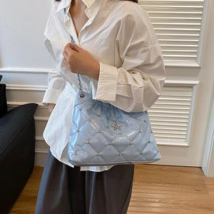 Light blue quilted shoulder bag with star metal ornament and silver chain strap
