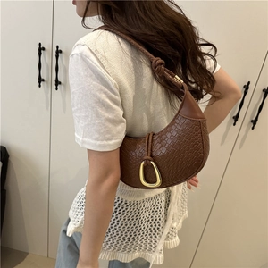 Deep brown woven hobo bag with U-shaped gold buckle and knotted shoulder strap detail