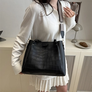 Large black crocodile pattern tote bag with wide geometric strap and gold hardware