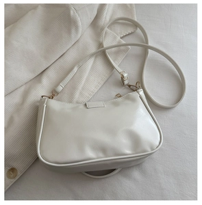 Detailed shot of white half-moon Hobo bag with glossy PU leather and golden hardware