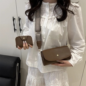 Three-piece brown tote bag set with wide geometric strap and matte leather finish